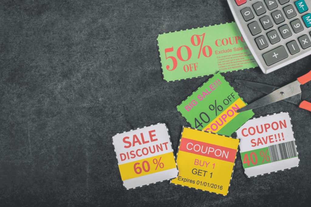 coupons spread out with a calculator and scissors
