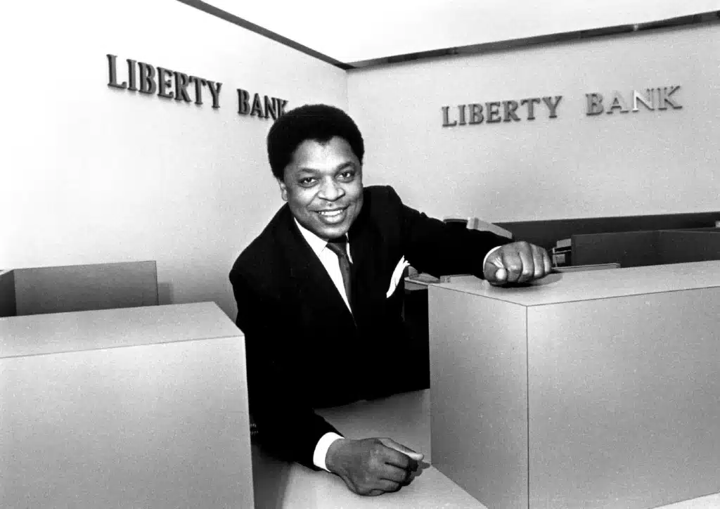 J. Thomas Wood, president of Liberty Bank, poses at an empty tellers window Dec. 1, 1987