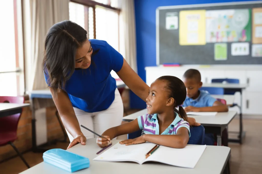 Financial Literacy In Schools? Here Are The Overlooked Pros And Cons 3 teacher and student representing financial literacy in schools