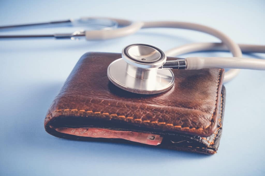 save money for investment concept Stethoscope and money  with filter effect retro vintage style representing limited purpose fsa