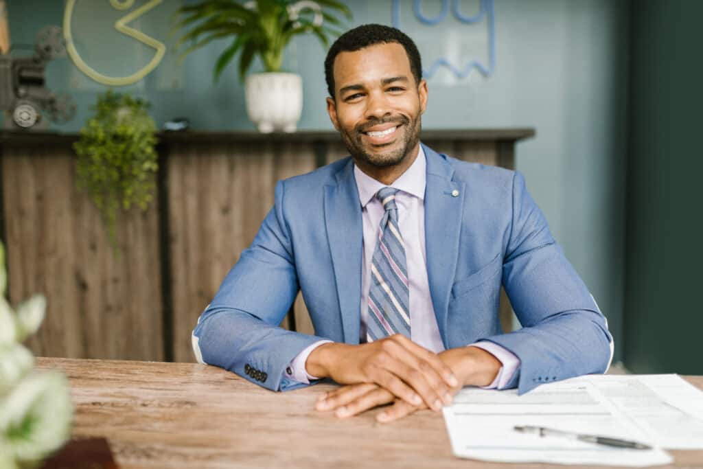black male in a suit representing a registered agent