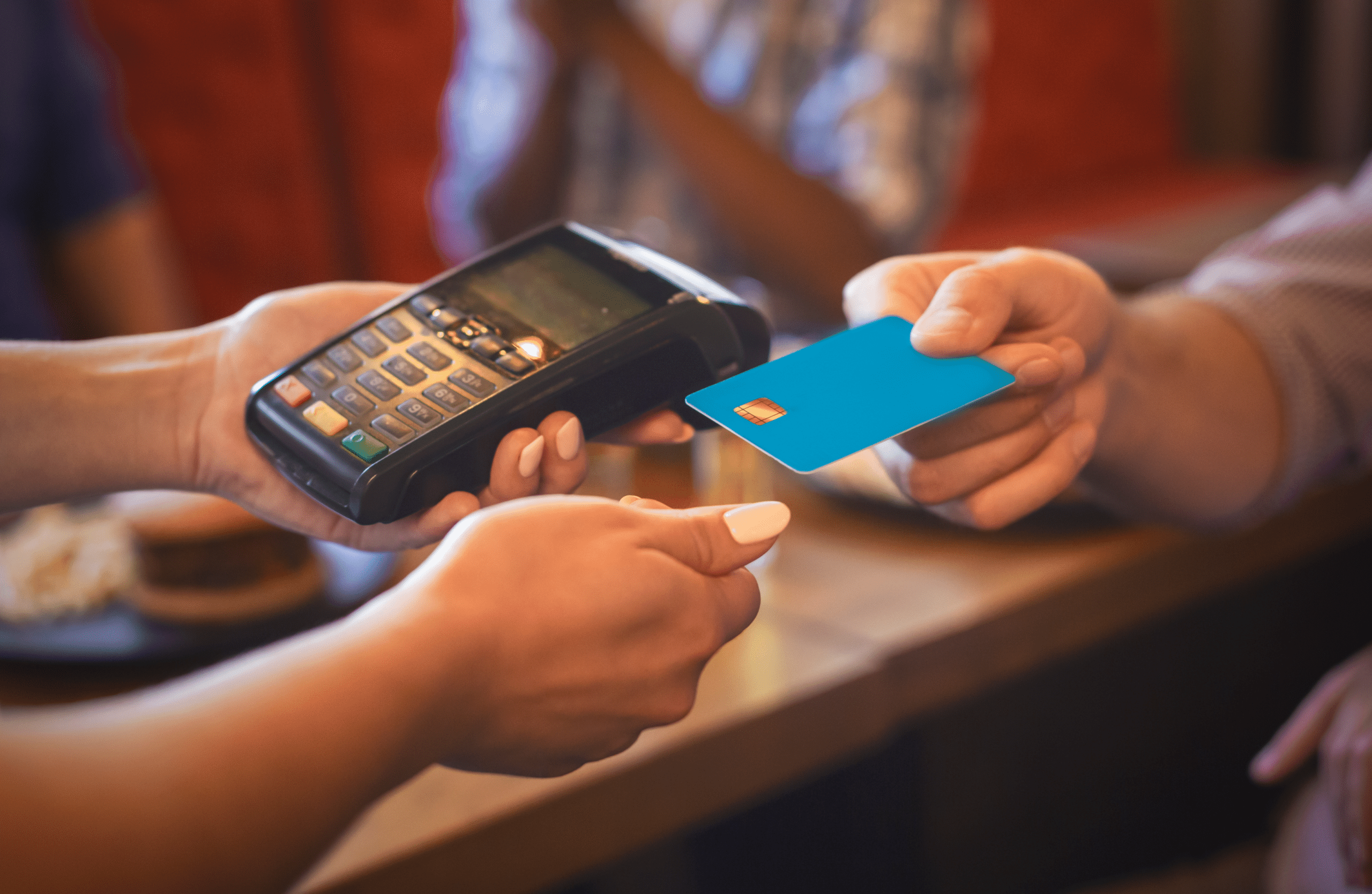 How to Choose a Credit Card: 7 Steps to Picking the Right Card 3 Female waitress swiping credit card at pub