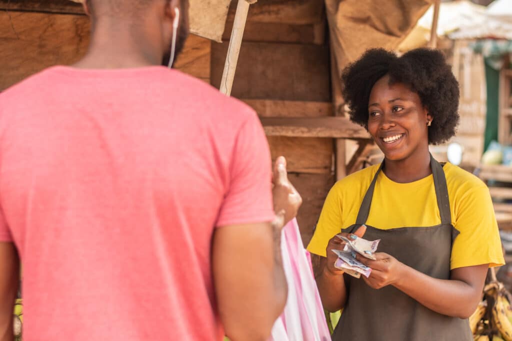 african woman and man bargaining in a market