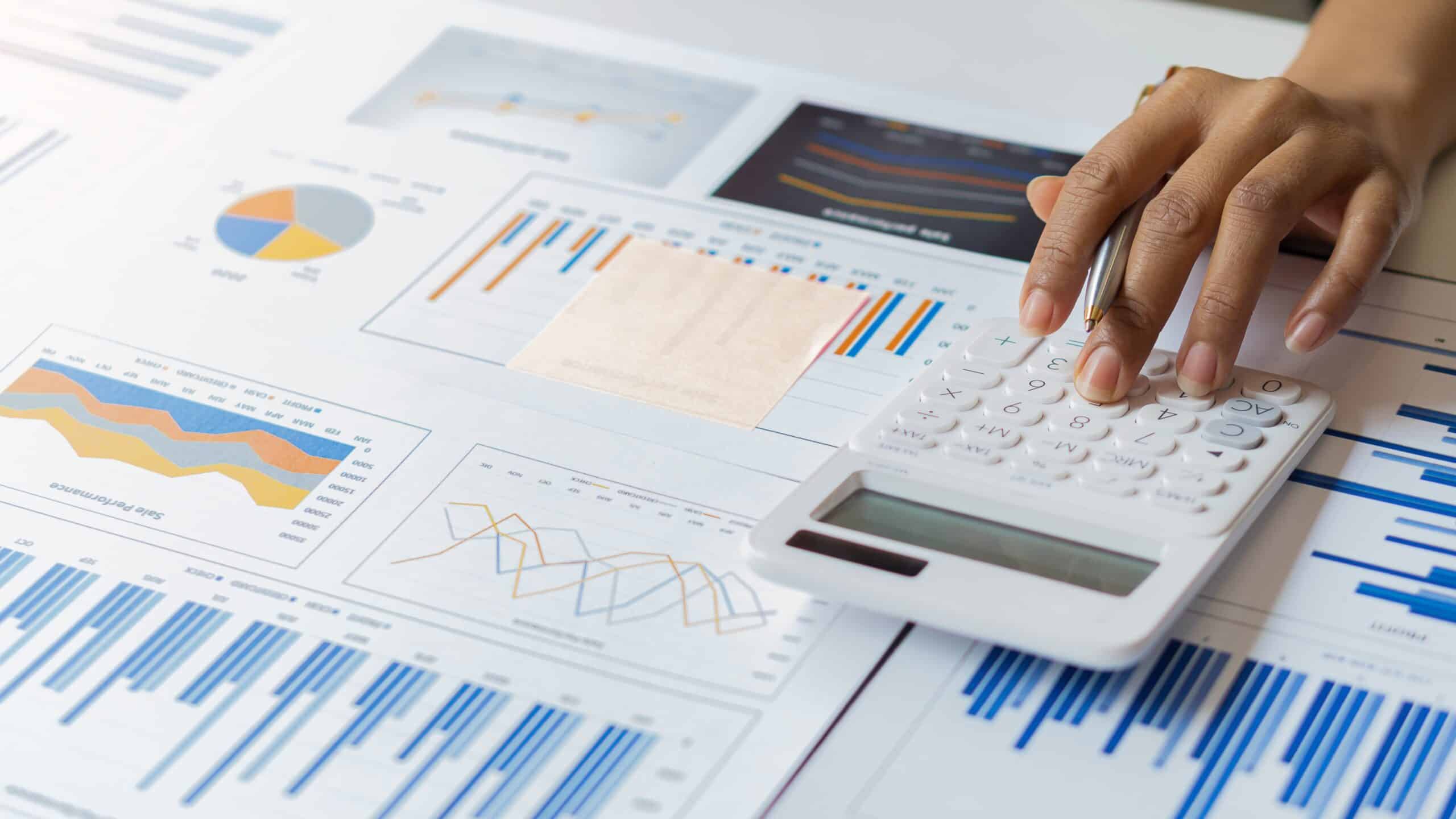 calculator and charts representing small business tax deductions
