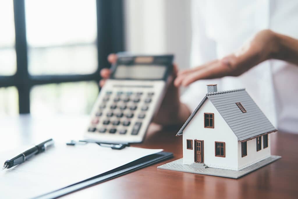 House model with real estate agent and customer discussing for contract to buy house, insurance or loan real estate background representing dscr loans