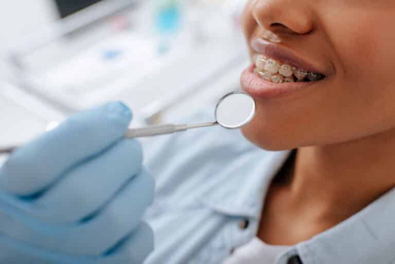 Person researching dental insurance options to help pay for braces